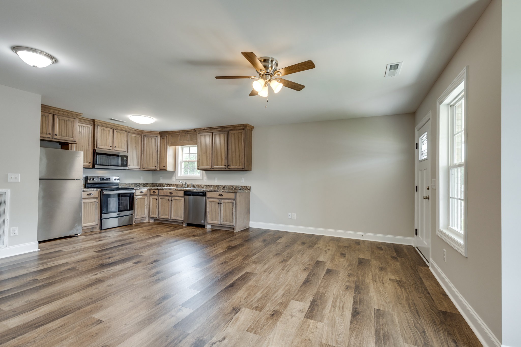 107 Ragsdale Lane Pulaski, TN 38478 - Photo 15 of 25 a kitchen with stainless steel appliances granite countertop a refrigerator a stove top oven a sink and dishwasher with wooden floor