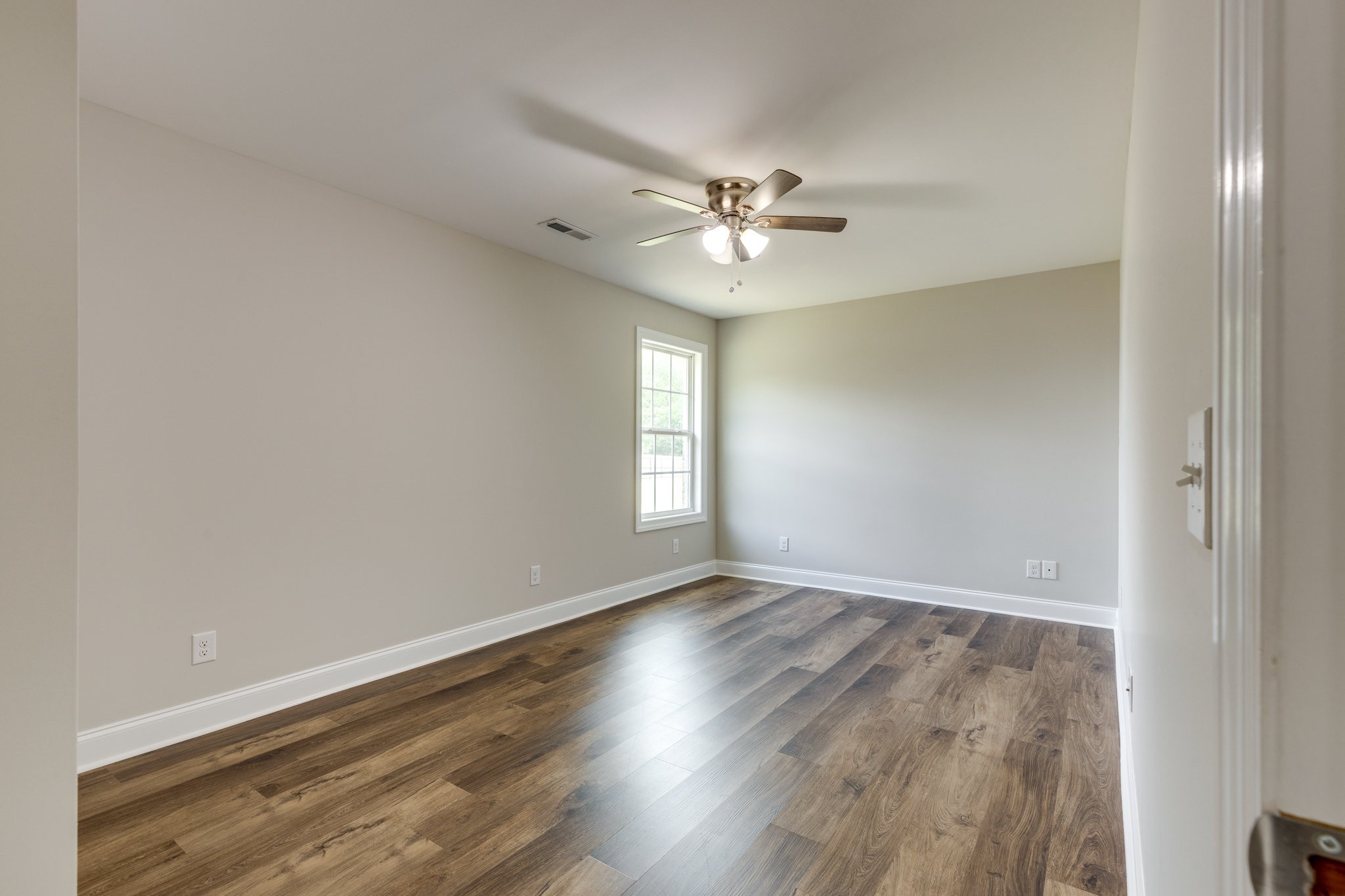 107 Ragsdale Lane Pulaski, TN 38478 - Photo 22 of 25 an empty room with wooden floor and windows