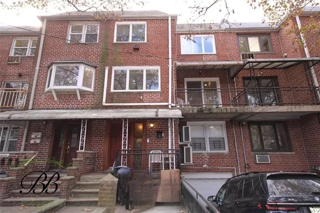 a front view of a house with many windows