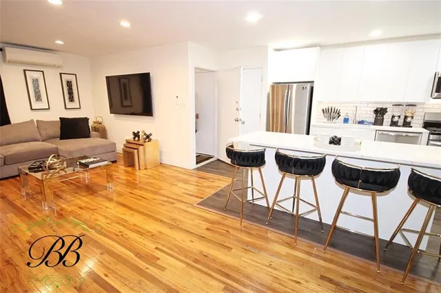a kitchen with stainless steel appliances kitchen island granite countertop a sink and cabinets