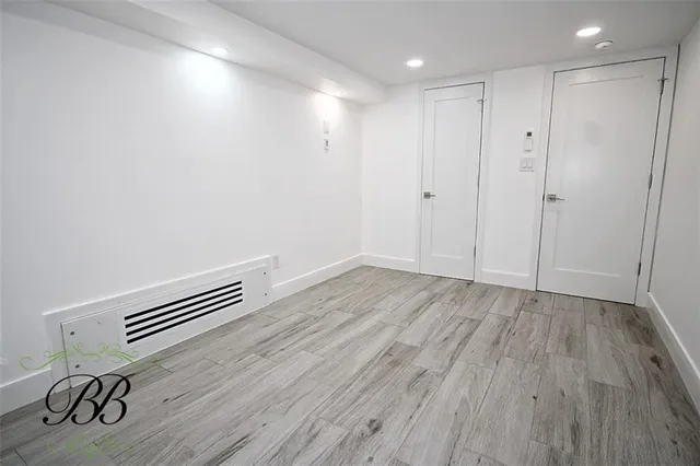 a view of room with wooden floor