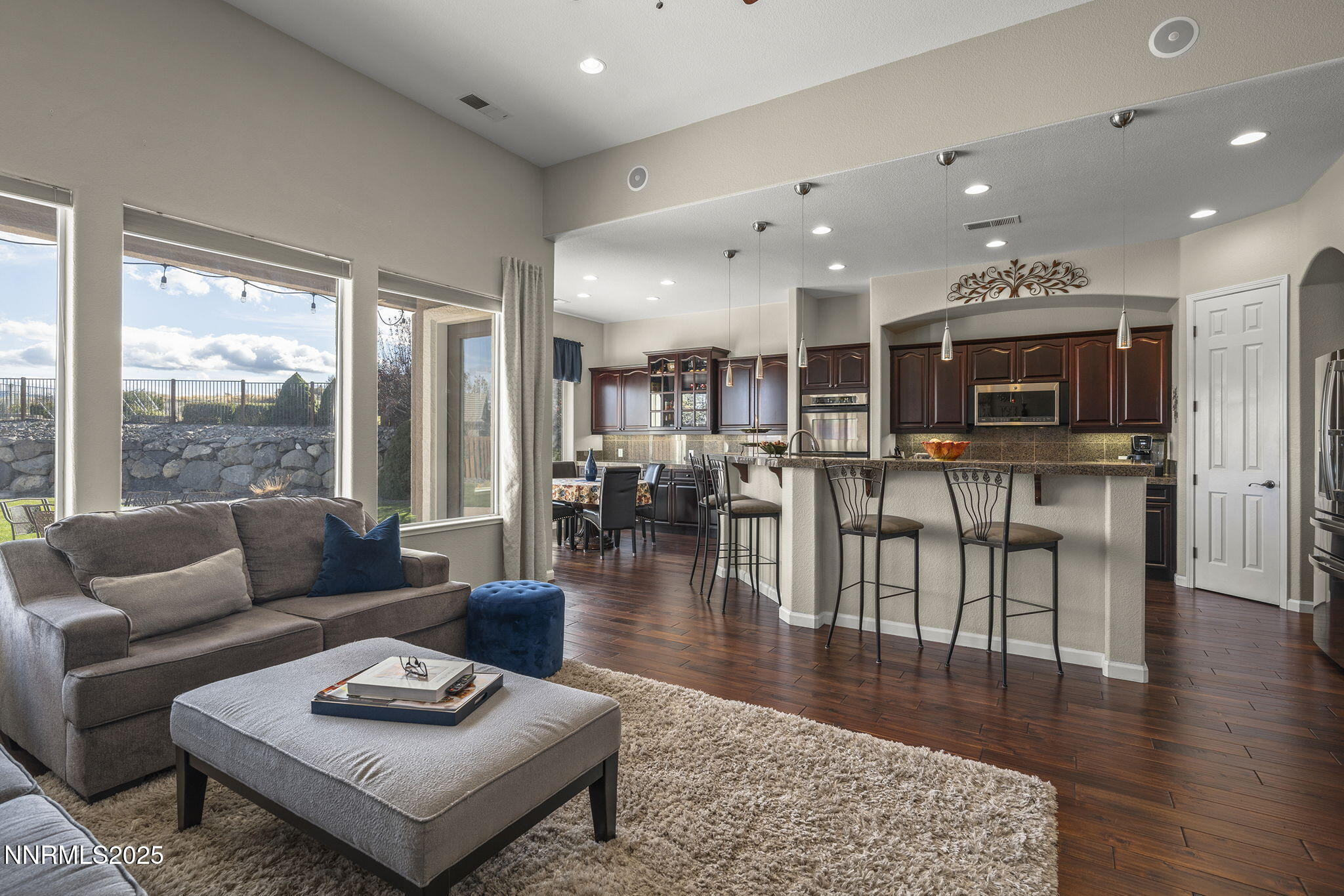 5502 New Mexico Court Reno, NV 89511 - Photo 11 of 55 a living room with furniture wooden floor and a large window