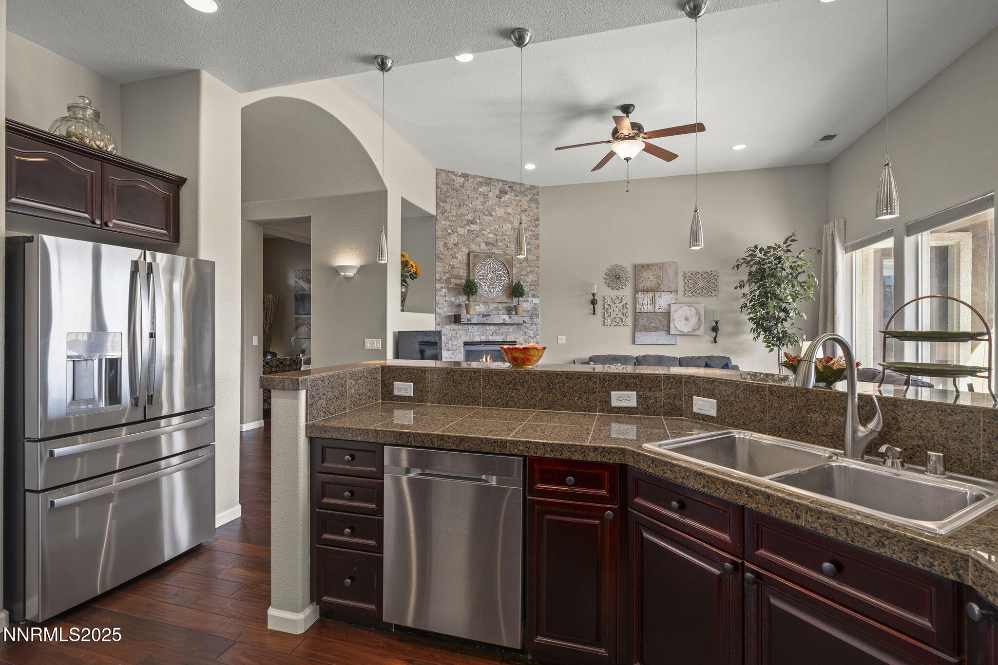 5502 New Mexico Court Reno, NV 89511 - Photo 15 of 55 a kitchen with stainless steel appliances granite countertop a sink and a refrigerator