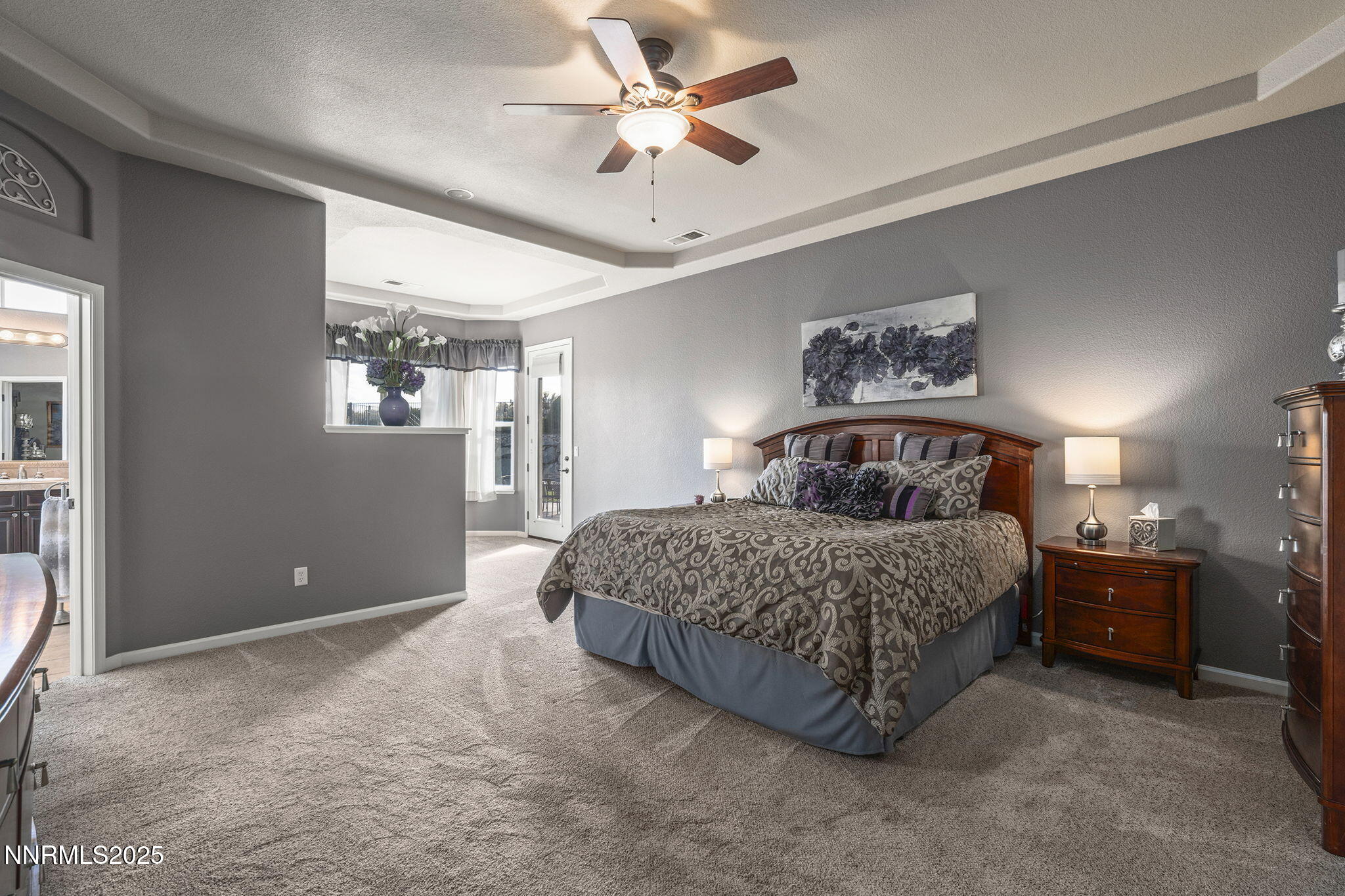 5502 New Mexico Court Reno, NV 89511 - Photo 18 of 55 a bedroom with a bed and a chandelier