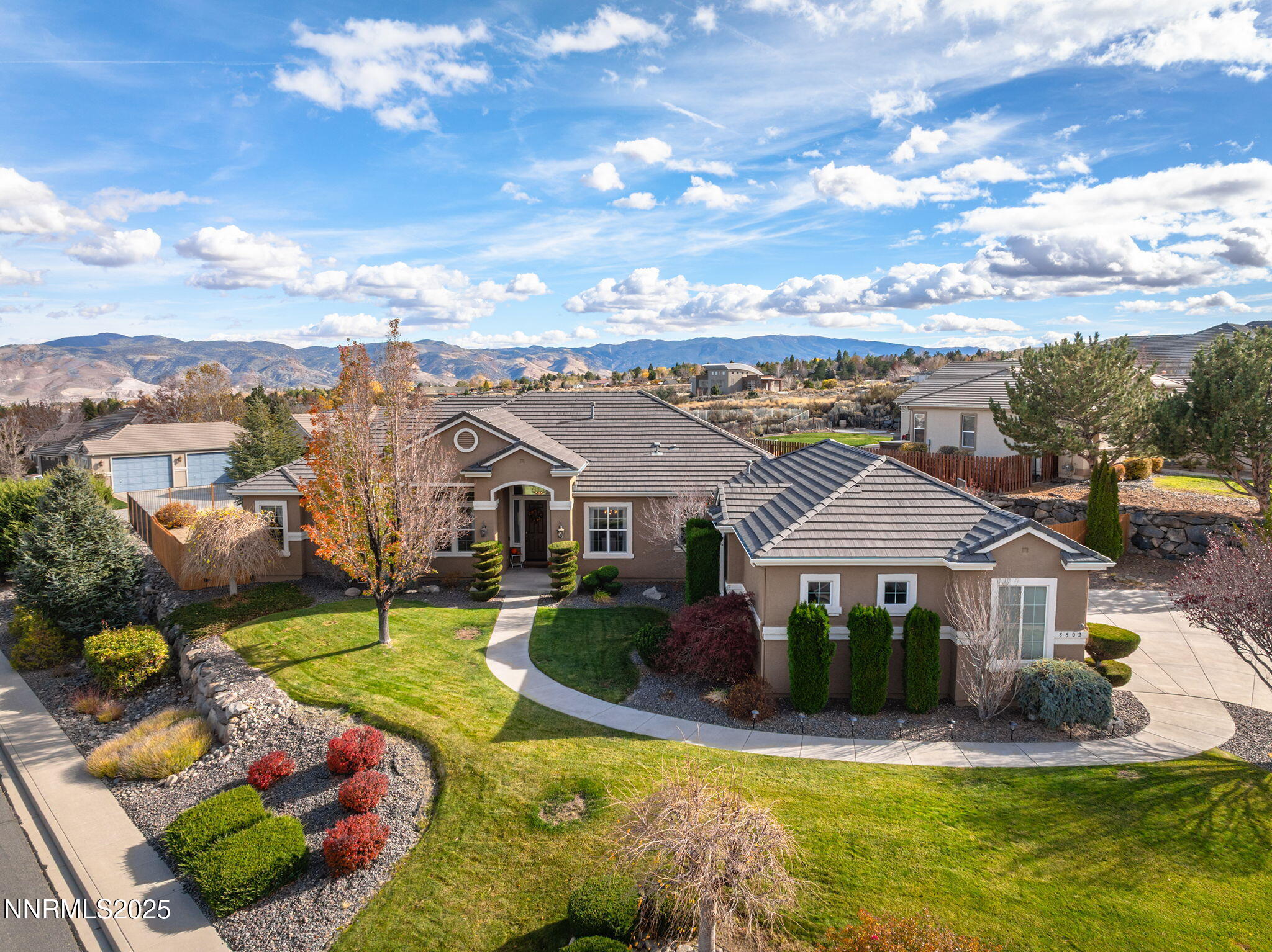 5502 New Mexico Court Reno, NV 89511 - Photo 2 of 55 a front view of a house with a garden and plants