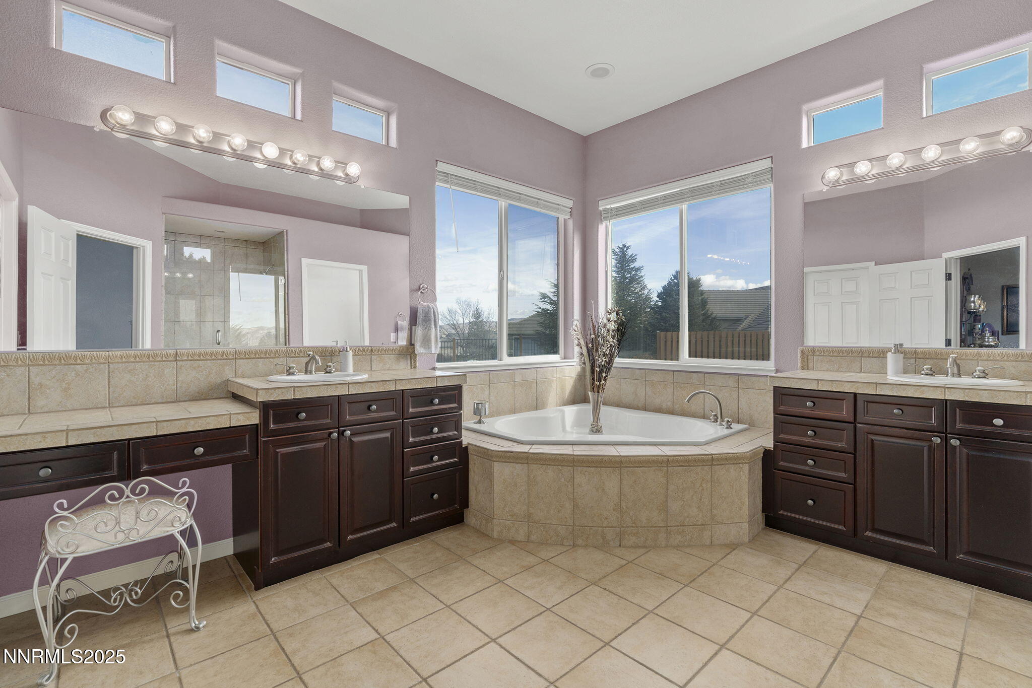 5502 New Mexico Court Reno, NV 89511 - Photo 21 of 55 a spacious bathroom with a sink vanity granite tub shower and a mirror