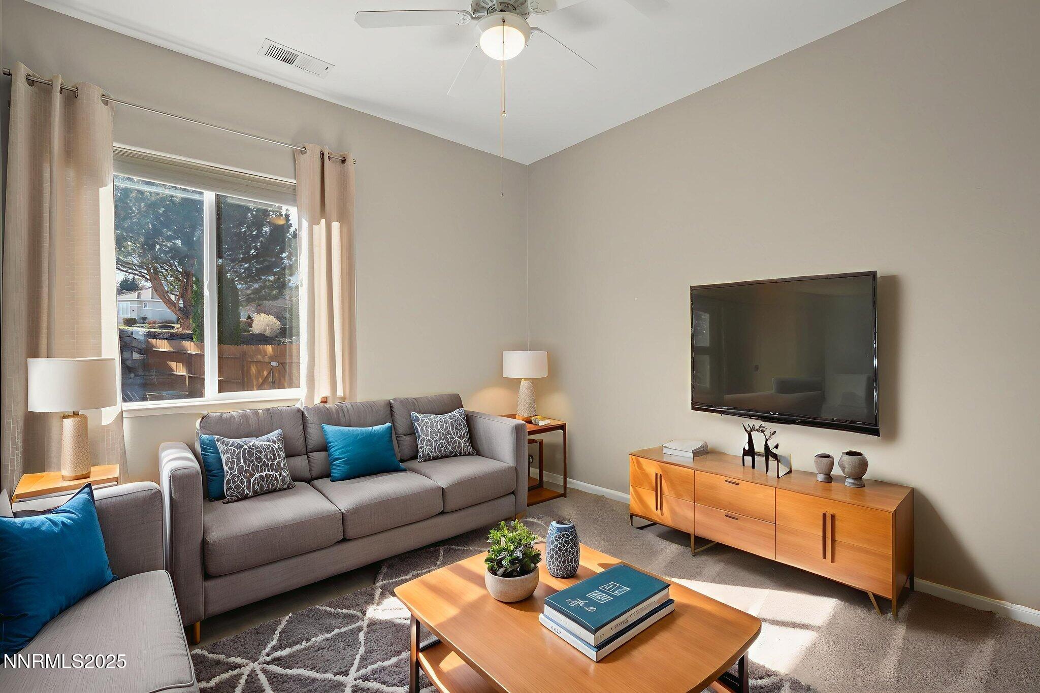 5502 New Mexico Court Reno, NV 89511 - Photo 26 of 55 a living room with furniture and a flat screen tv