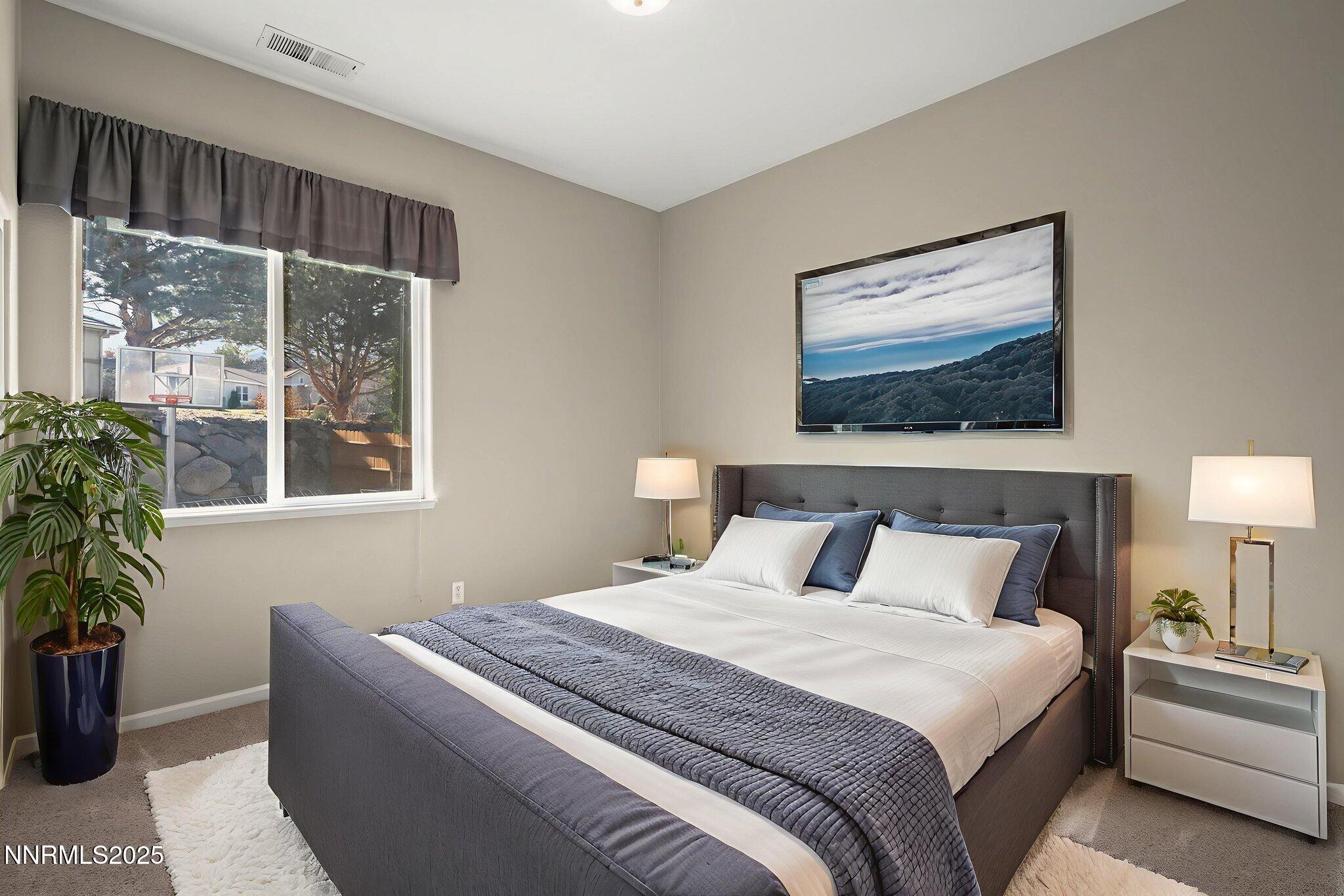 5502 New Mexico Court Reno, NV 89511 - Photo 28 of 55 a bedroom with bed and window