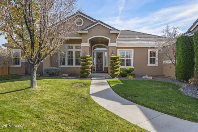 a front view of house with yard and green space
