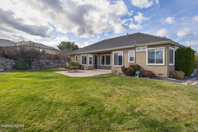a front view of a house with a yard and trees