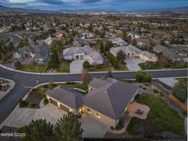 an aerial view of a house with yard swimming pool and outdoor seating