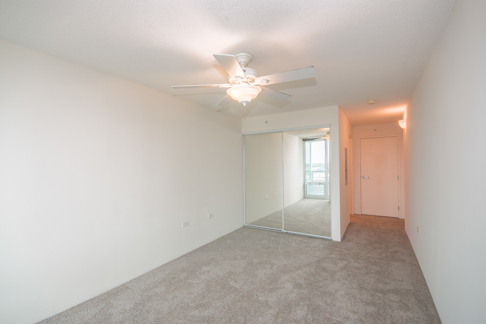 800 Elgin Road, Unit 1206 Evanston, IL 60201 - Photo 12 of 18 an empty room with chandelier fan and windows