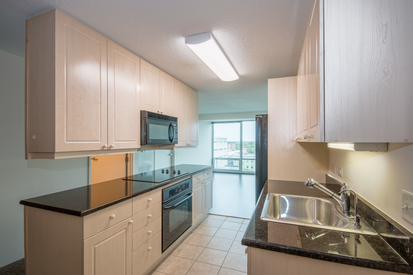 800 Elgin Road, Unit 1206 Evanston, IL 60201 - Photo 5 of 18 a kitchen that has a sink and a stove in it
