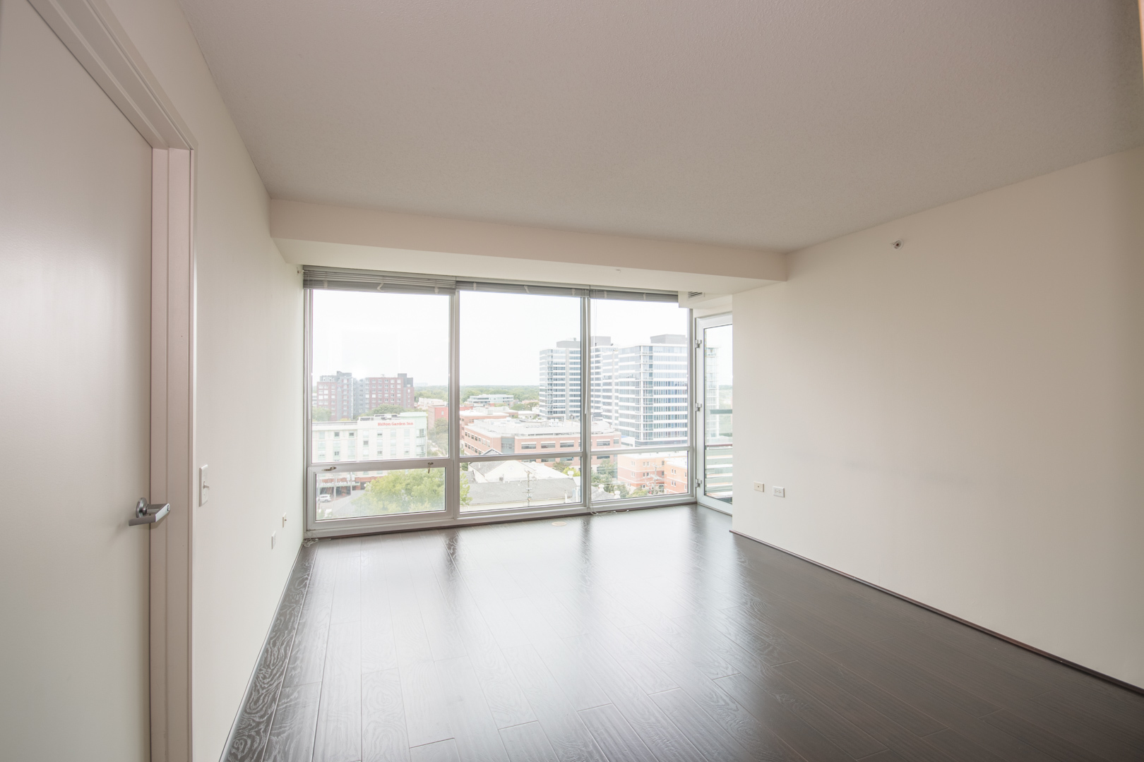 800 Elgin Road, Unit 1206 Evanston, IL 60201 - Photo 7 of 18 wooden floor in an empty room with a window