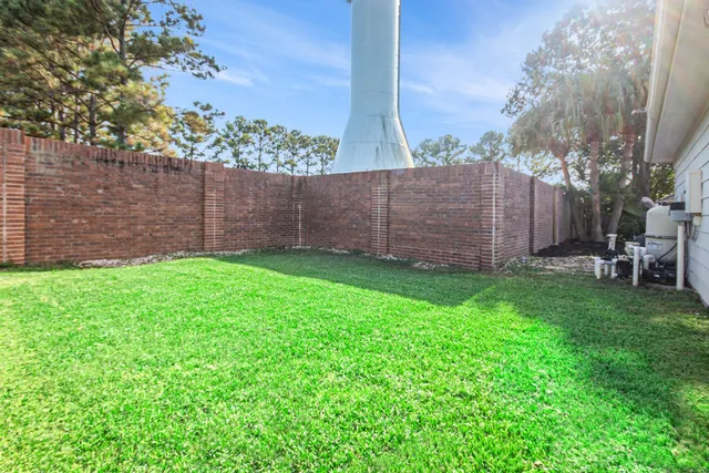 a view of a backyard with a garden and entertaining space