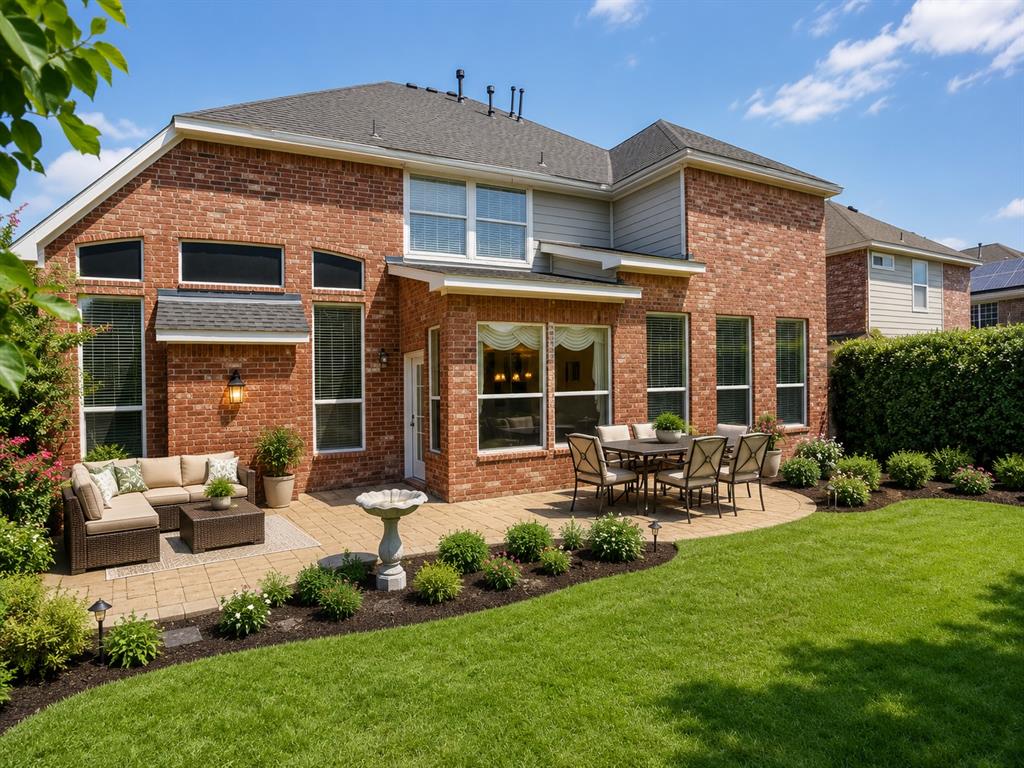 5708 Rickshaw Lane Plano, TX 75094 - Photo 28 of 28 Brick exterior featuring multiple windows and a shingled roof