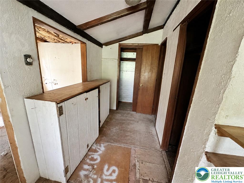 3540 Mountain Road, Unit 3538 Slatington, PA 18080 - Photo 9 of 27 Exposed wood beams and built-in storage cabinets define this rustic hallway layout.