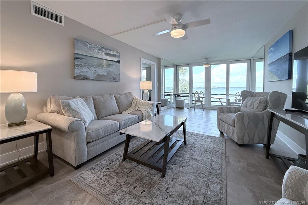 1950 Southwest Palm City Road, Unit 14305 Stuart, FL 34994 - Photo 12 of 70 a living room with furniture and a large window