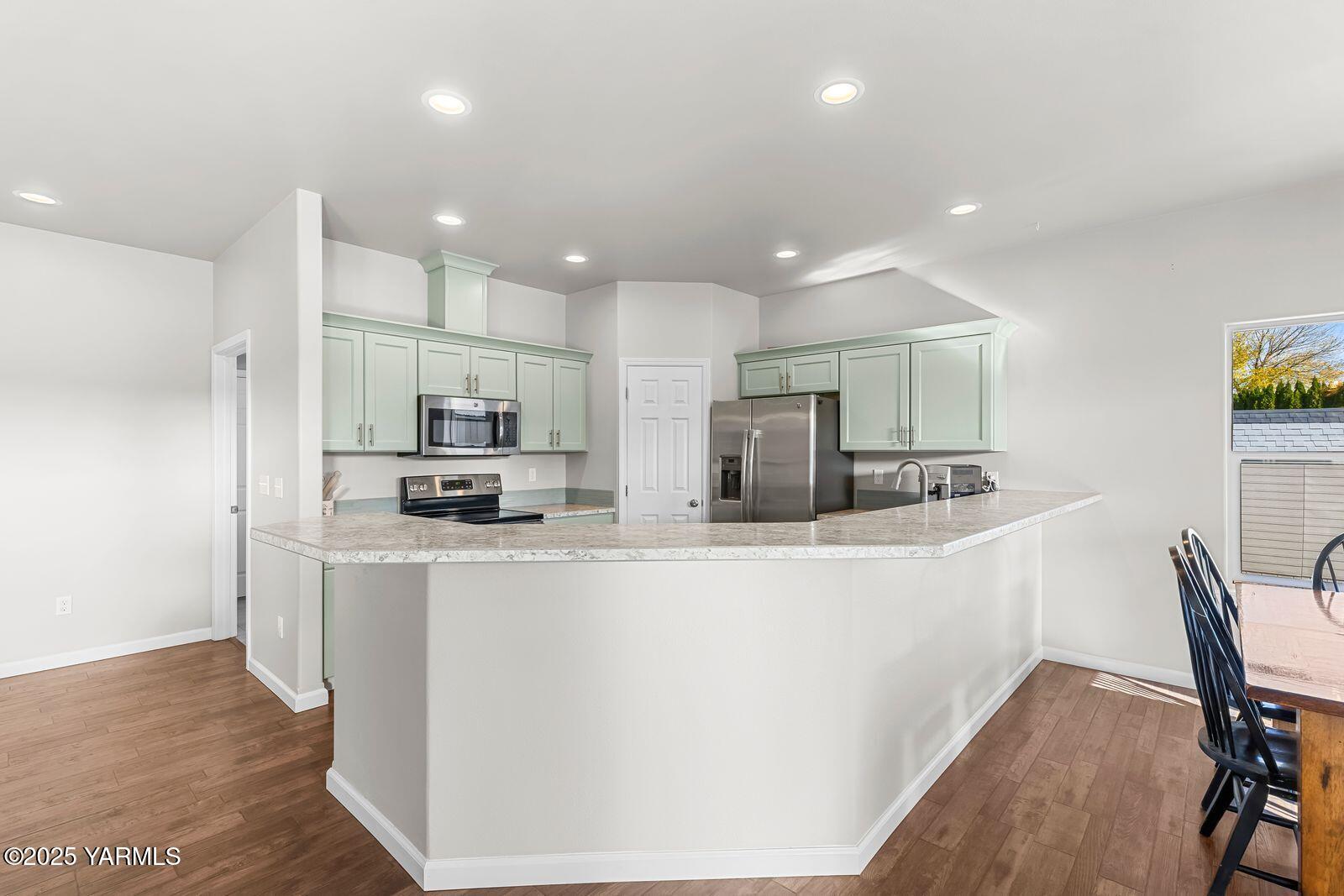115 Apple Loop Naches, WA 98937 - Photo 12 of 48 a kitchen with stainless steel appliances a refrigerator and a stove top oven