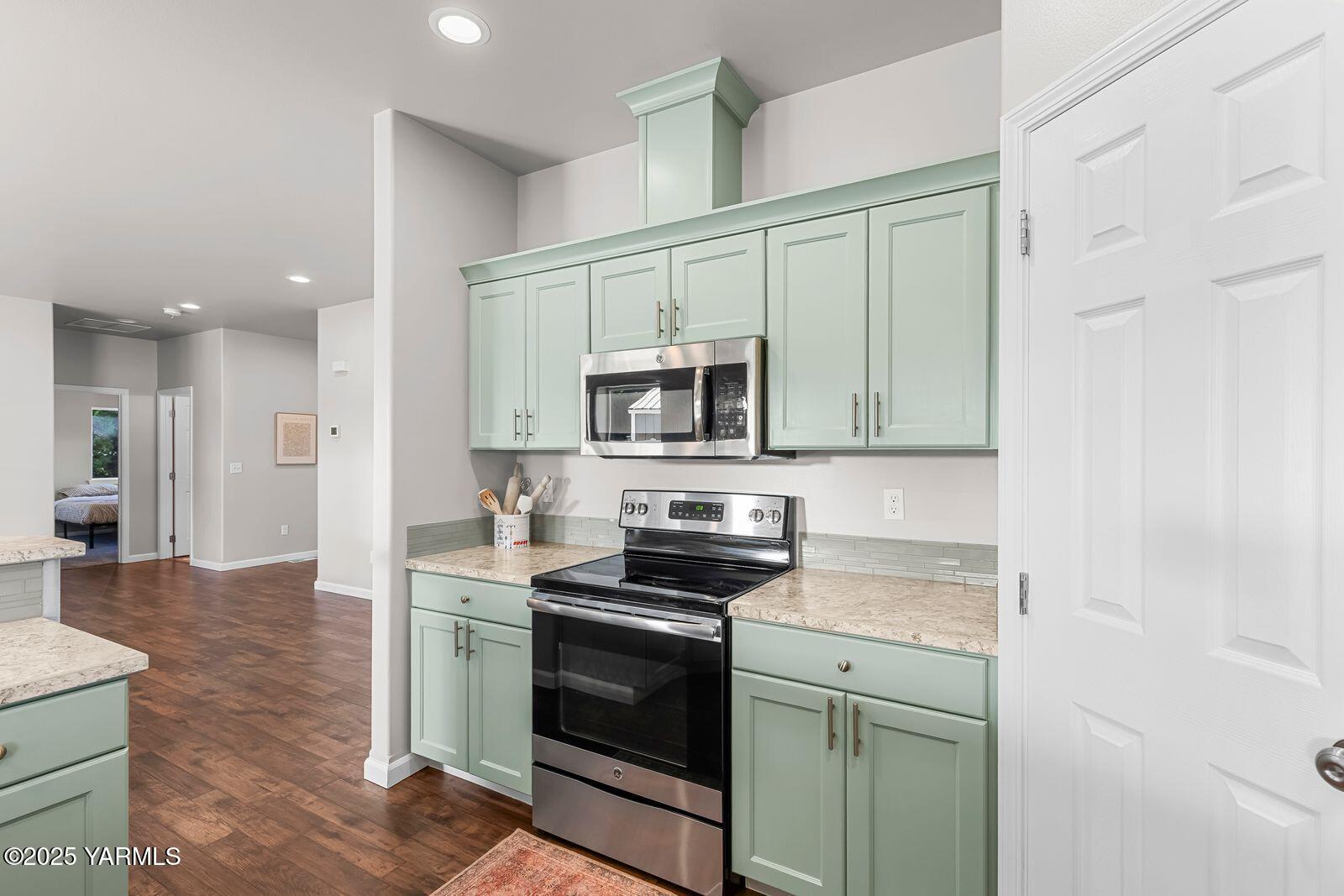 115 Apple Loop Naches, WA 98937 - Photo 14 of 48 a kitchen with stainless steel appliances granite countertop a stove a microwave and a refrigerator