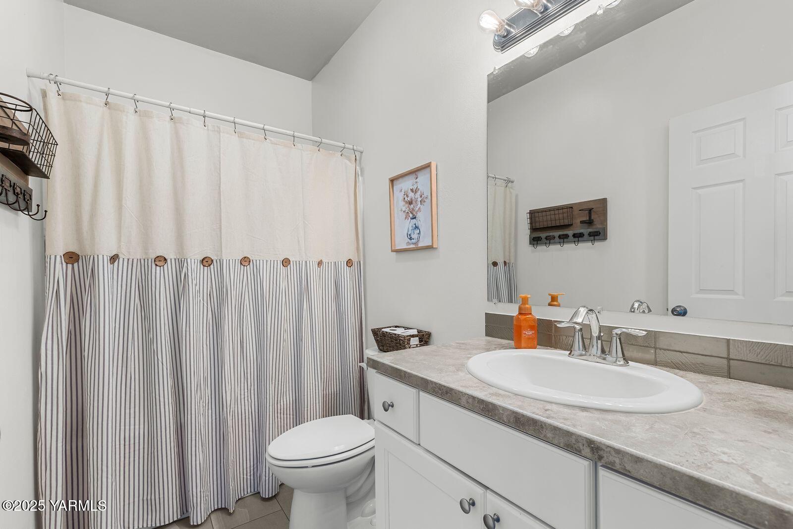 115 Apple Loop Naches, WA 98937 - Photo 18 of 48 a bathroom with a granite countertop sink and a mirror with toilet