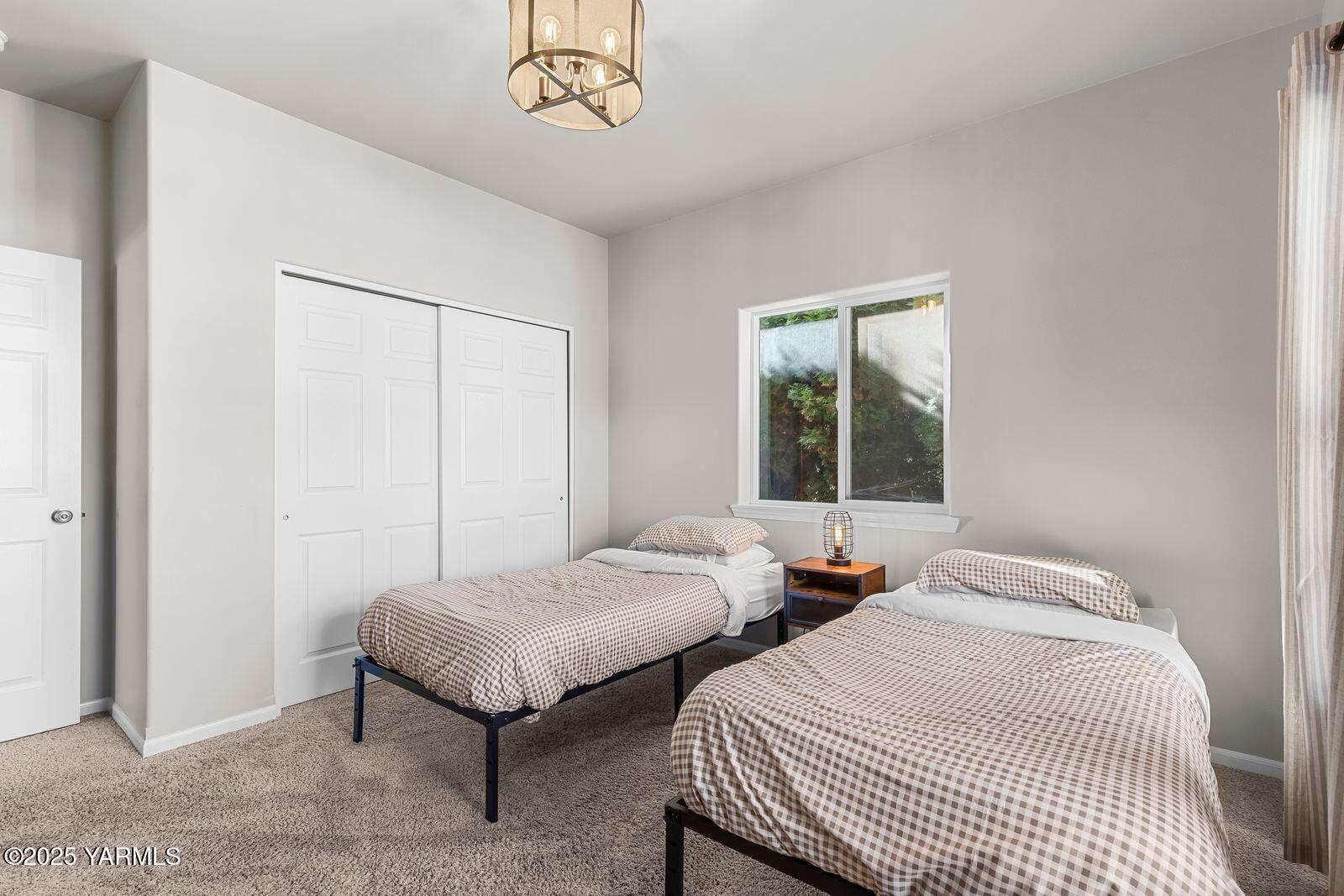 115 Apple Loop Naches, WA 98937 - Photo 20 of 48 a bedroom with two beds and a window