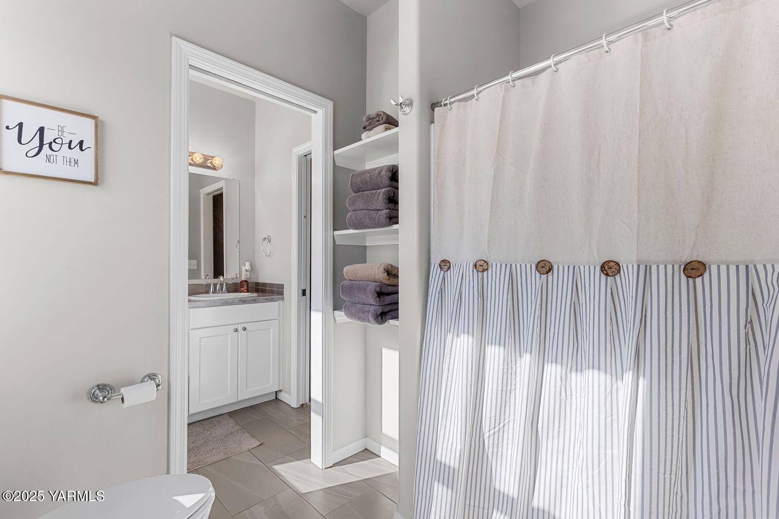 115 Apple Loop Naches, WA 98937 - Photo 25 of 48 a bathroom with a granite countertop sink and a mirror