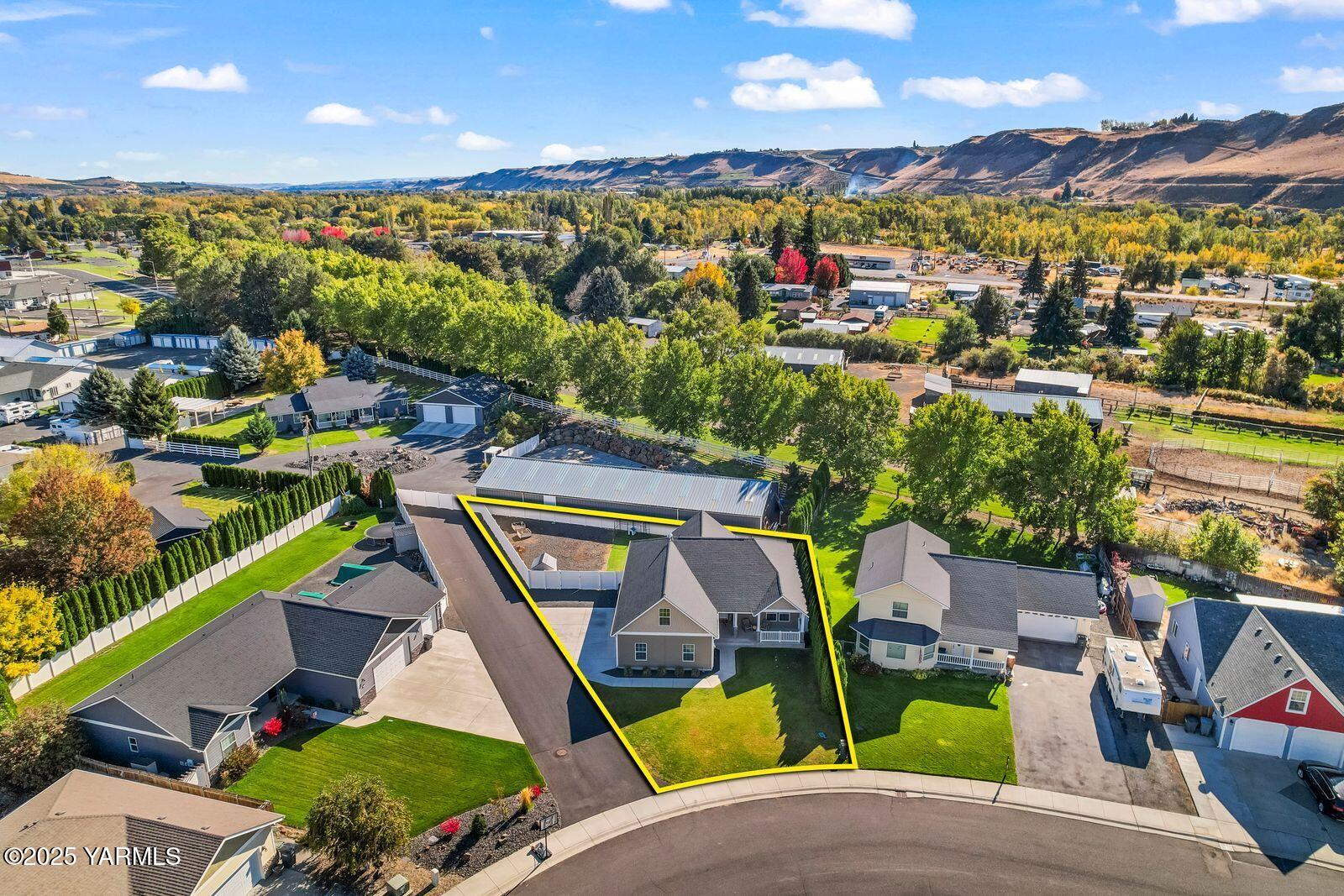 115 Apple Loop Naches, WA 98937 - Photo 37 of 48 an aerial view of a house with a swimming pool a patio and mountain view