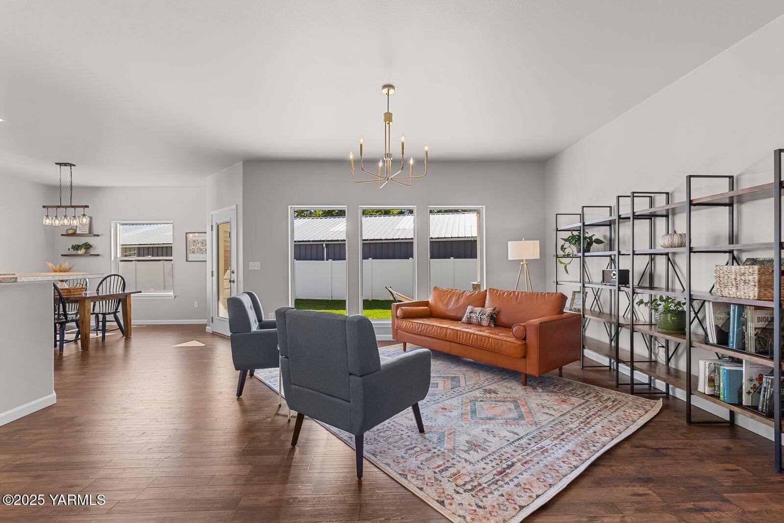 115 Apple Loop Naches, WA 98937 - Photo 8 of 48 a living room with furniture a rug and a chandelier