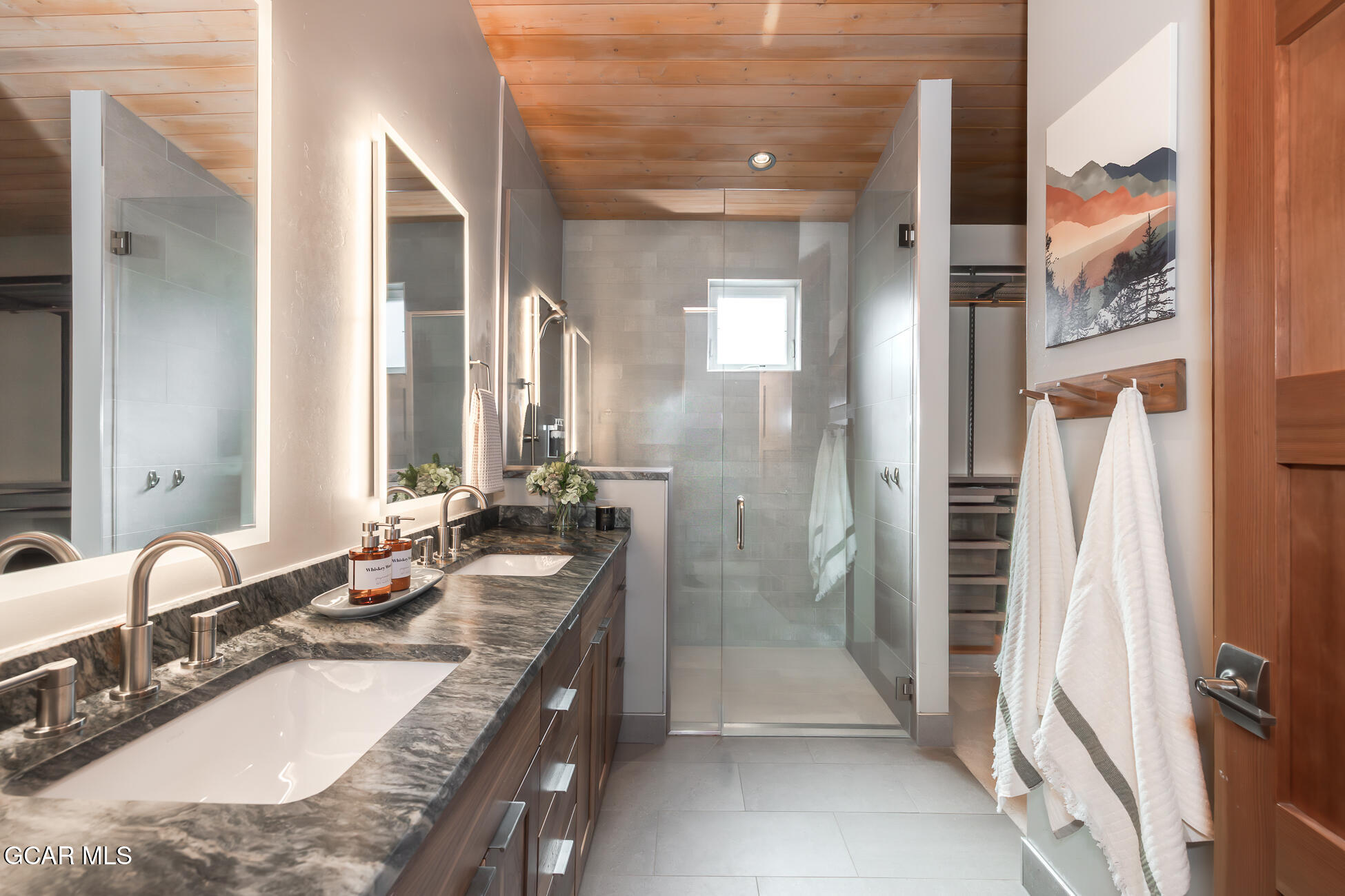 684 Vasquez Road Winter Park, CO 80482 - Photo 22 of 45 a bathroom with a granite countertop sink a mirror and a shower