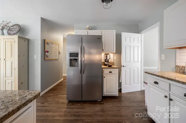 a kitchen with stainless steel appliances granite countertop a refrigerator and a sink