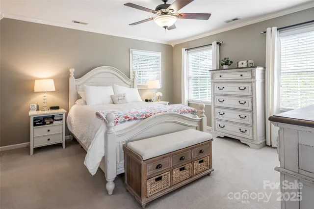 a spacious bedroom with a bed and a dresser