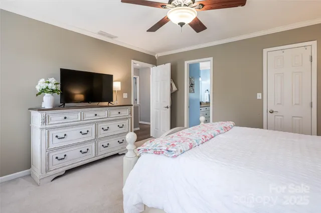 a bedroom with a bed and a flat screen tv in a dresser