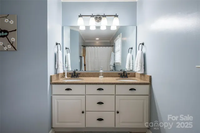 a bathroom with a granite countertop sink a mirror and a vanity