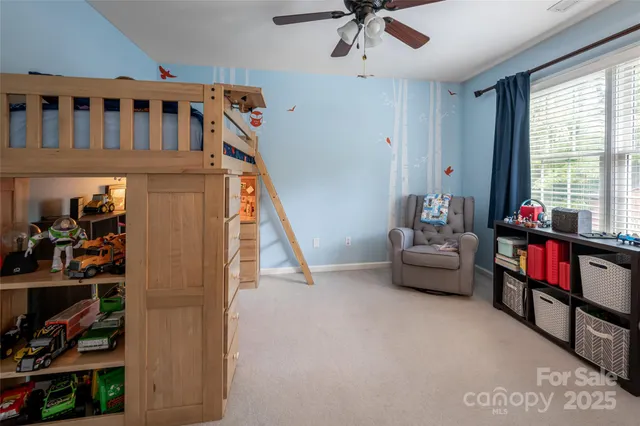 a living room with furniture and a book shelf