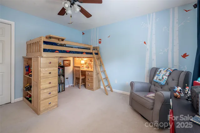 a living room with furniture and a ceiling fan