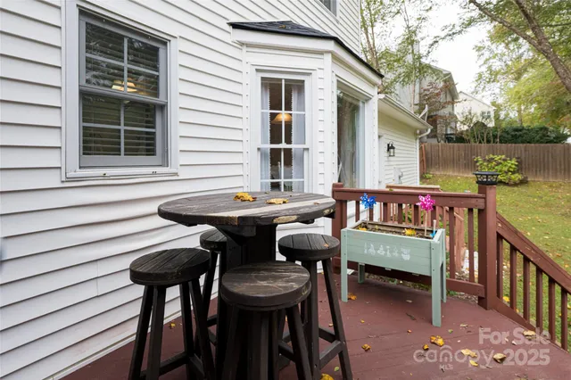 a view of a patio with table and chairs and floor to ceiling window