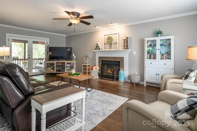 a living room with furniture a fireplace and a flat screen tv