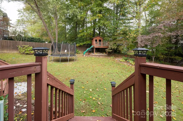 a view of a house with a yard and furniture