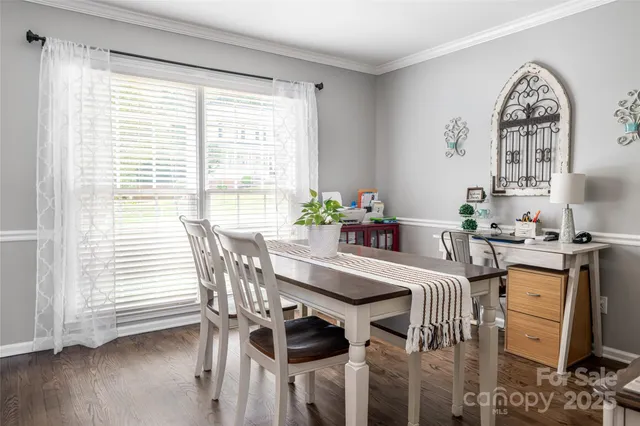 a view of a dining room with furniture and windows