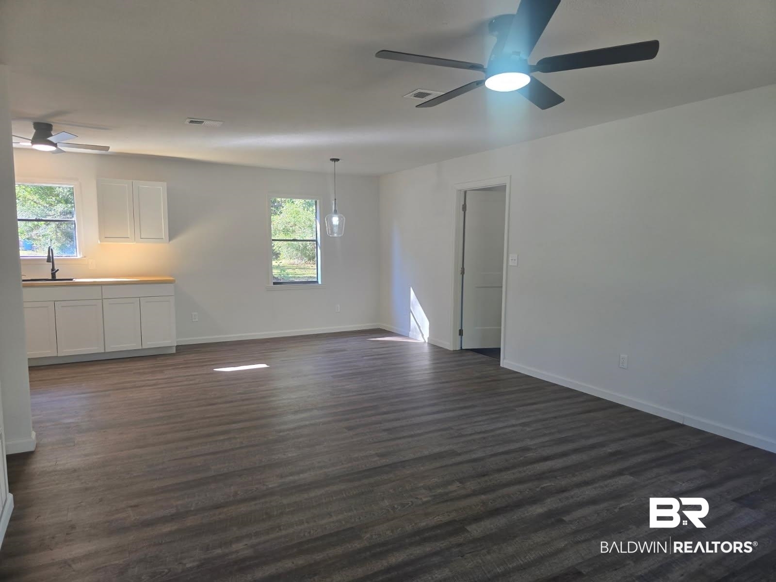 1404 Dailey Street Brewton, AL 36426 - Photo 5 of 25 Unfurnished living room featuring ceiling fan and dark wood finished floors