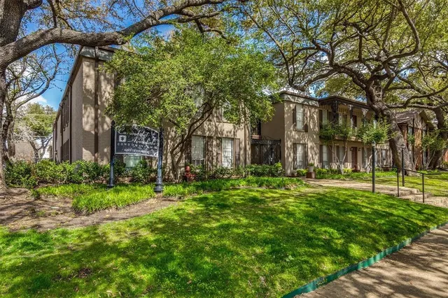 a backyard of a house with lots of green space and fountain