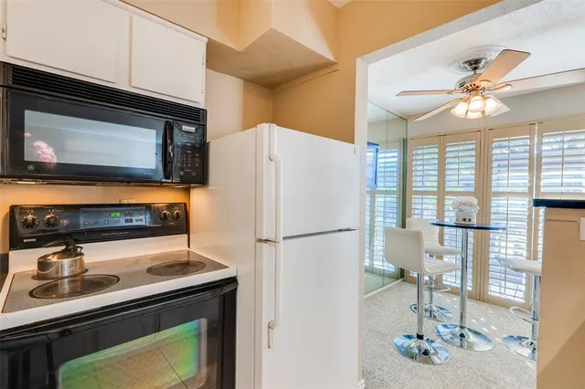 a kitchen with stainless steel appliances a refrigerator a sink and cabinets