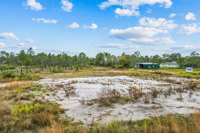 a view of a lake with houses in the background
