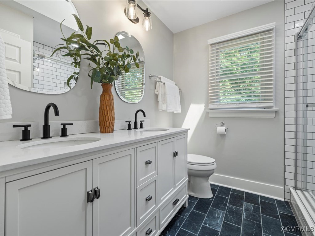 1519 Kingscross Road Midlothian, VA 23114 - Photo 36 of 50 a bathroom with a toilet a sink and a window