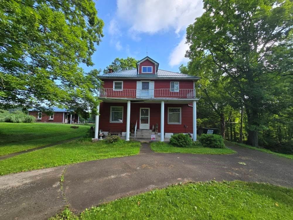 a view of a brick house with a yard