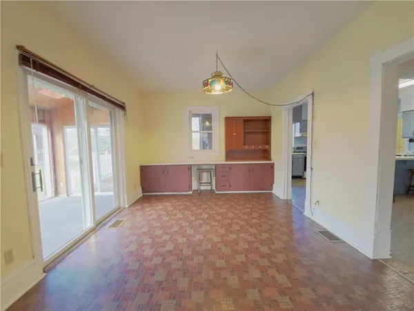 a view of a big room with windows and cabinet