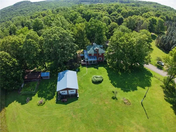 an aerial view of a house with yard swimming pool and outdoor seating