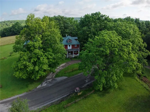 an aerial view of a house with a yard basket ball court and outdoor seating