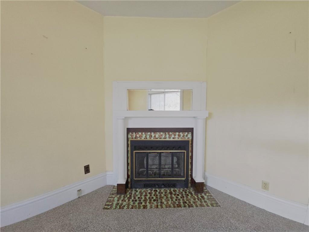 273 Government Road New Bethlehem, PA 16242 - Photo 8 of 33 a living room with a fireplace and a rug